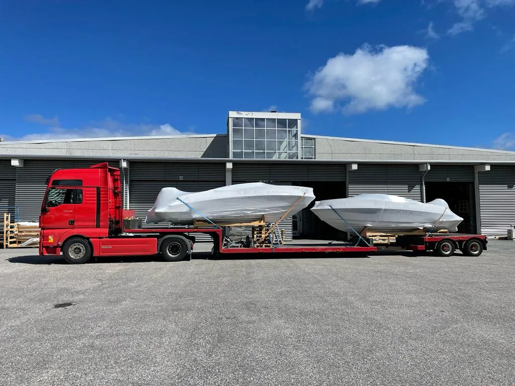 Two motor cruisers on a single low-loader trailer.